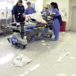 Civilian And Military Medical Personnel Treat A Patient In The Trauma