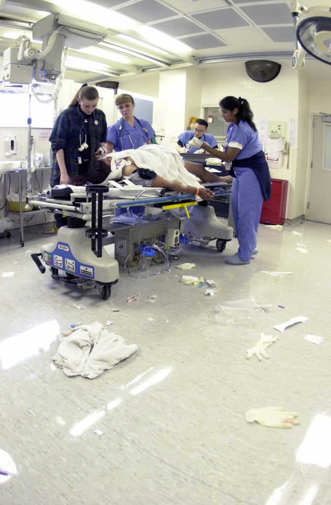 Civilian And Military Medical Personnel Treat A Patient In The Trauma 